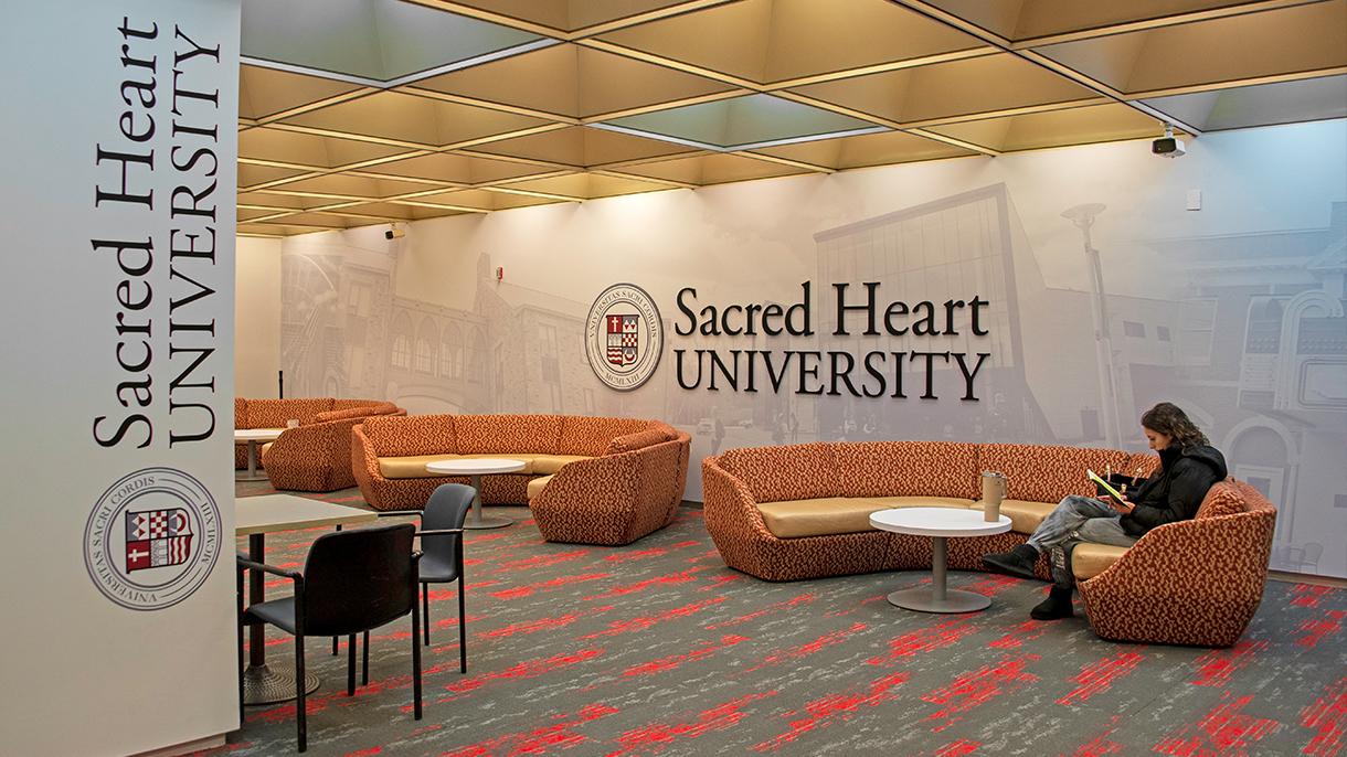 a college student sitting on a couch studying