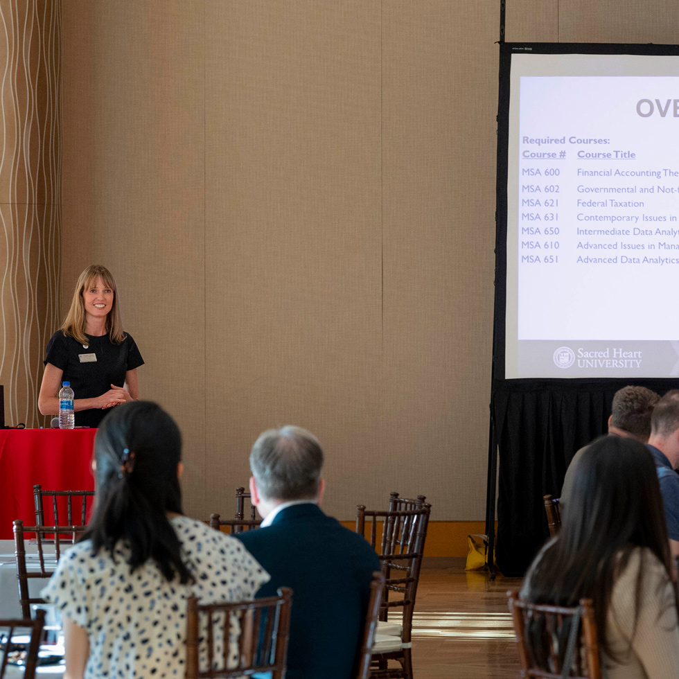 Woman speaking to students at orientation