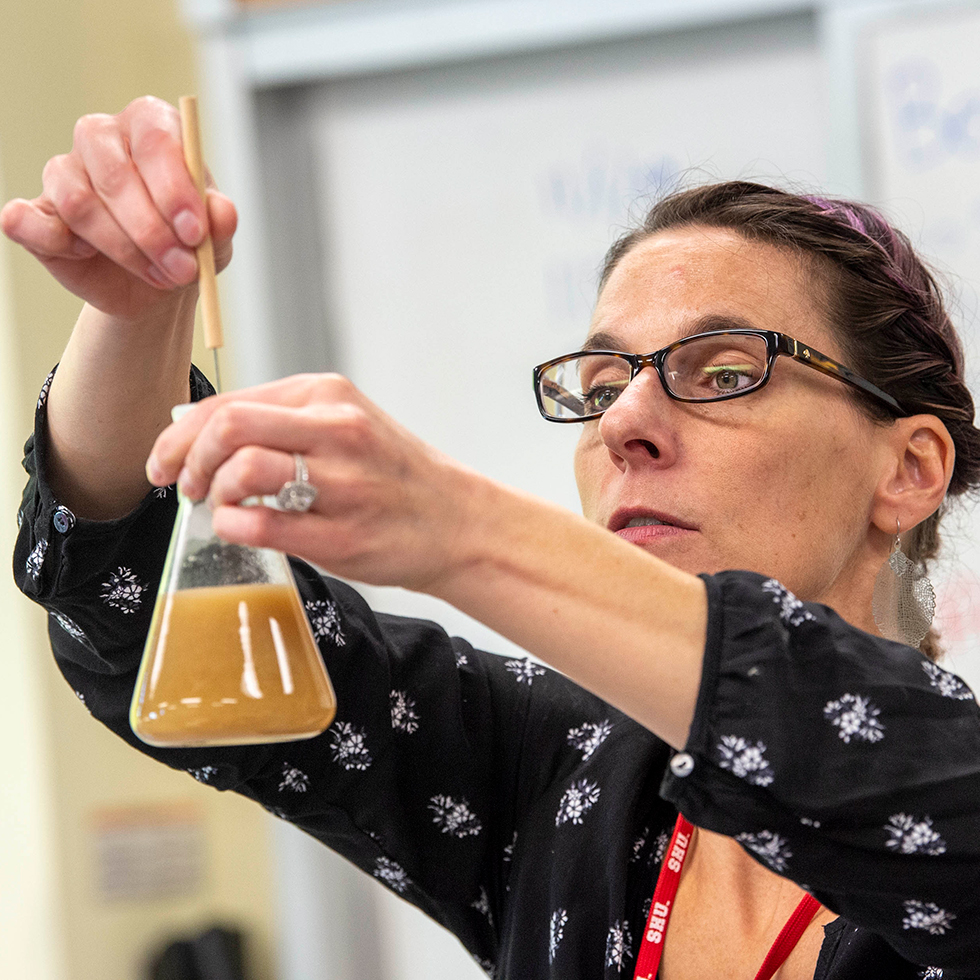 professor holding a beaker