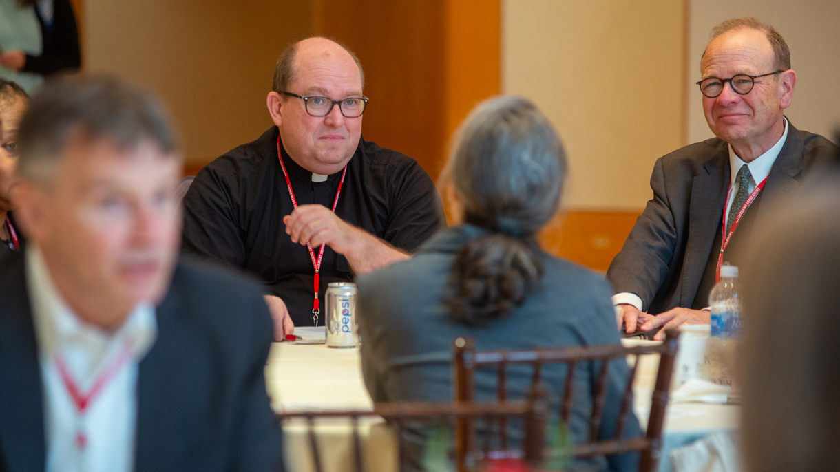 Catholic Studies Symposium participants engage is small group discussions