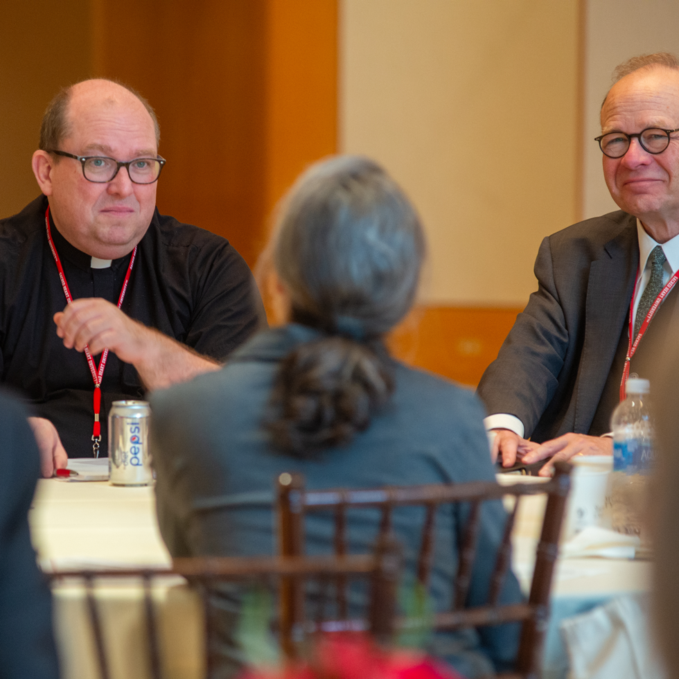 Catholic Studies Symposium participants engage is small group discussions