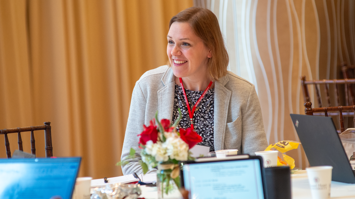 Woman sitting at table smiling