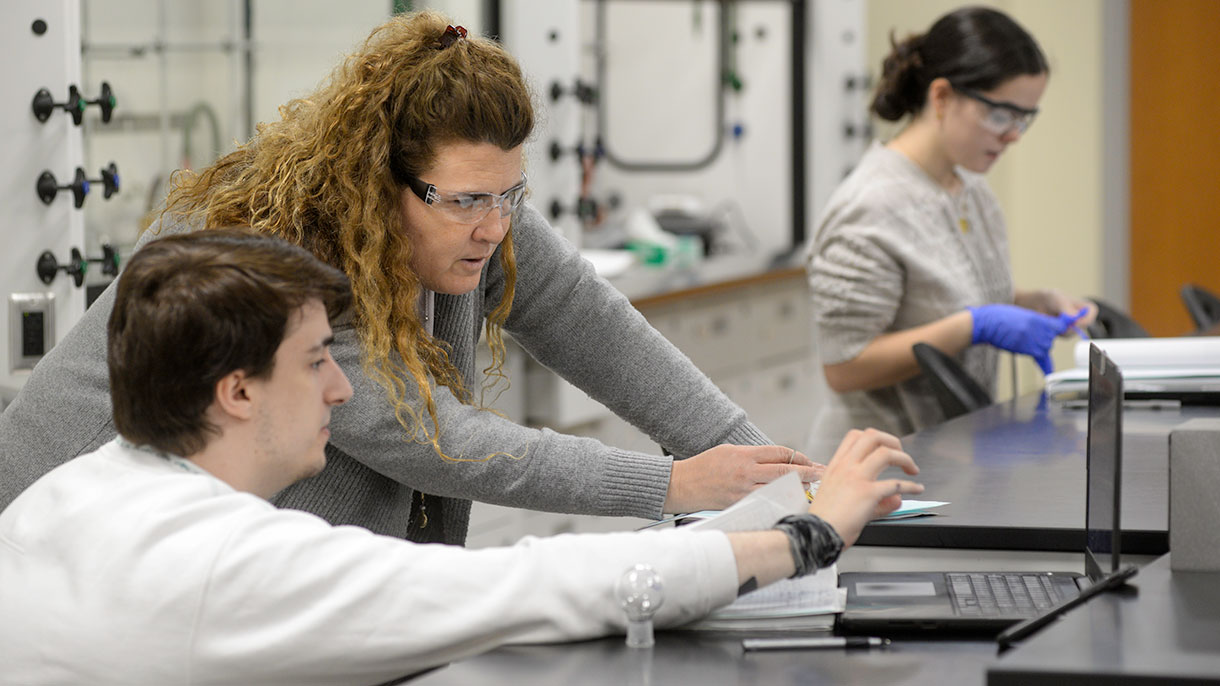 chemistry professor helping a student