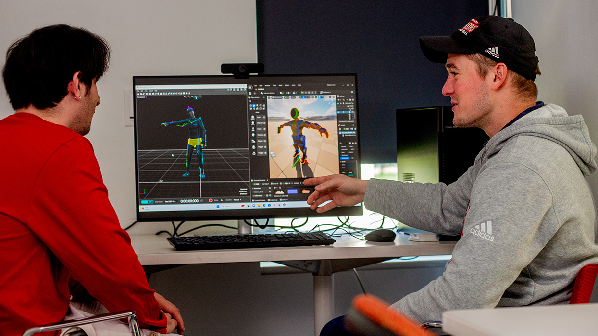college students collaborating at computers in a motion capture lab