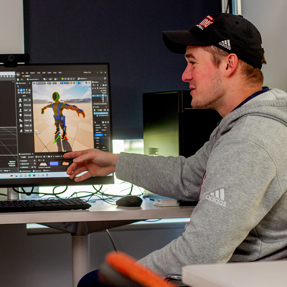 college students collaborating at computers in a motion capture lab