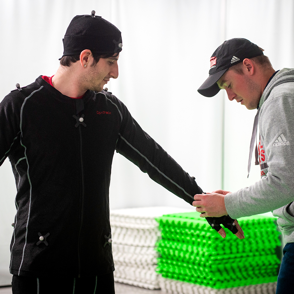 A student model puts on a motion capture suit