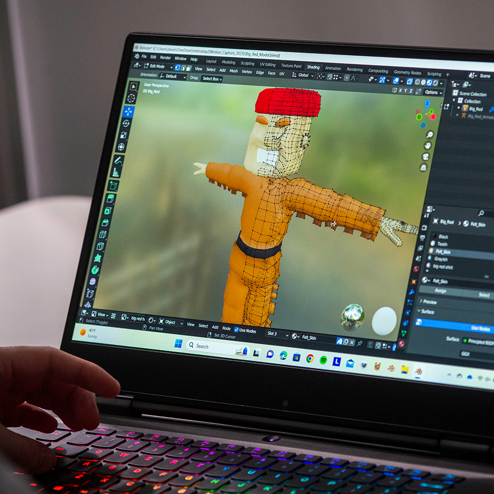 animation on a laptop screen of SHU mascot Big Red the Pioneer