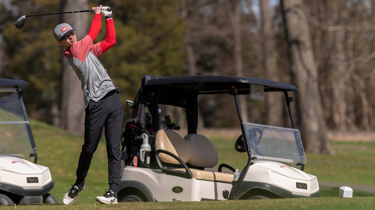 A WCBT student tees off at the 2022 Welch Cup Classic golf tournament.