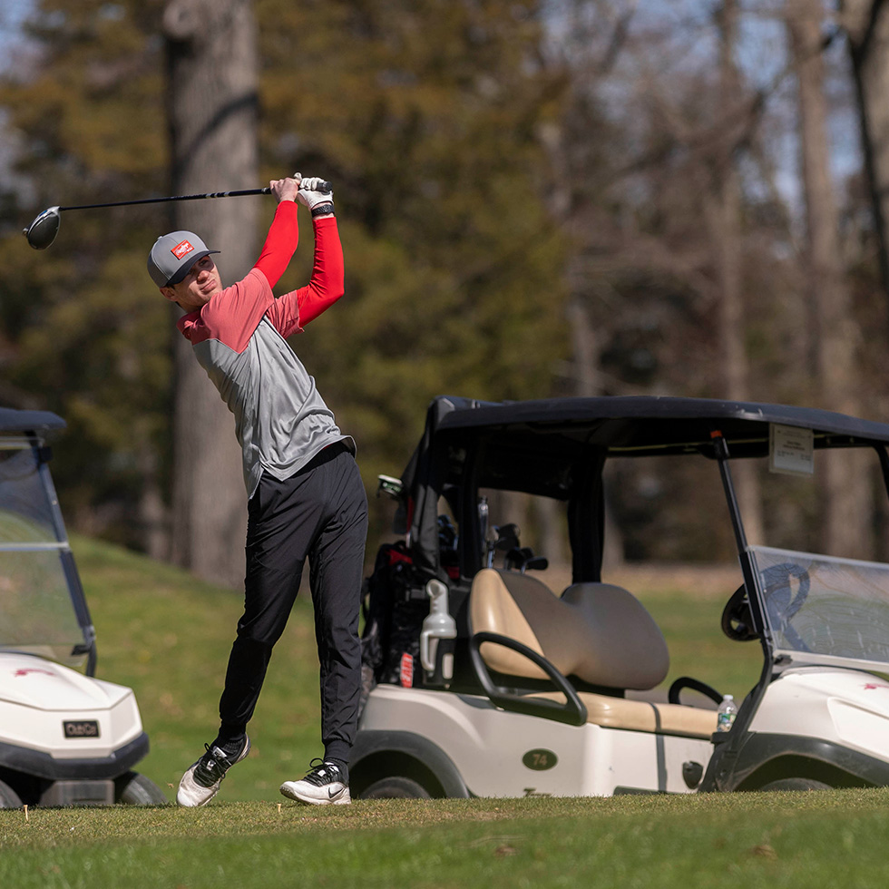 A WCBT student tees off at the 2022 Welch Cup Classic golf tournament.