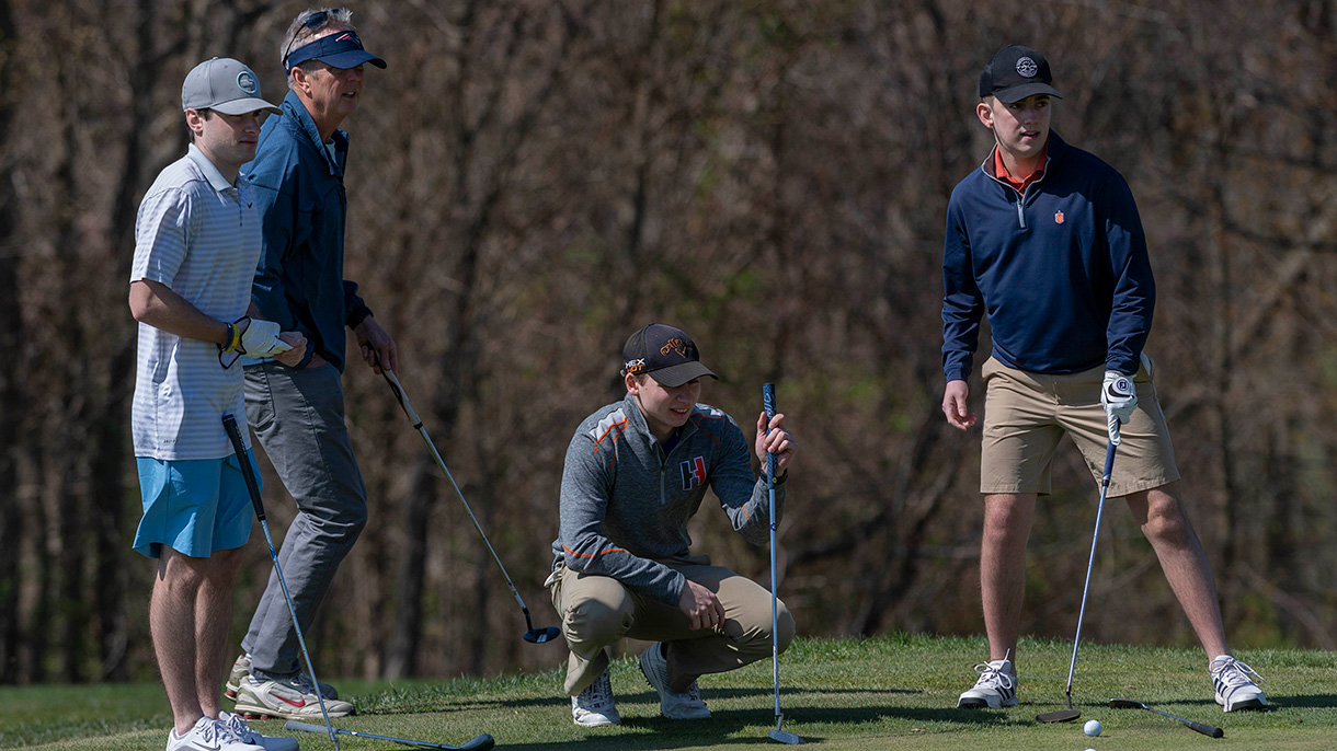 A golfer evaluates his putt at the Welch Cup Classic golf tournament.
