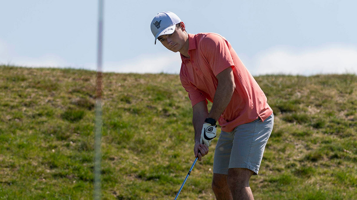 Golfer lines up his putt on the 10th green.