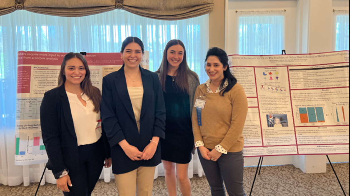 A group of women standing in front of posters