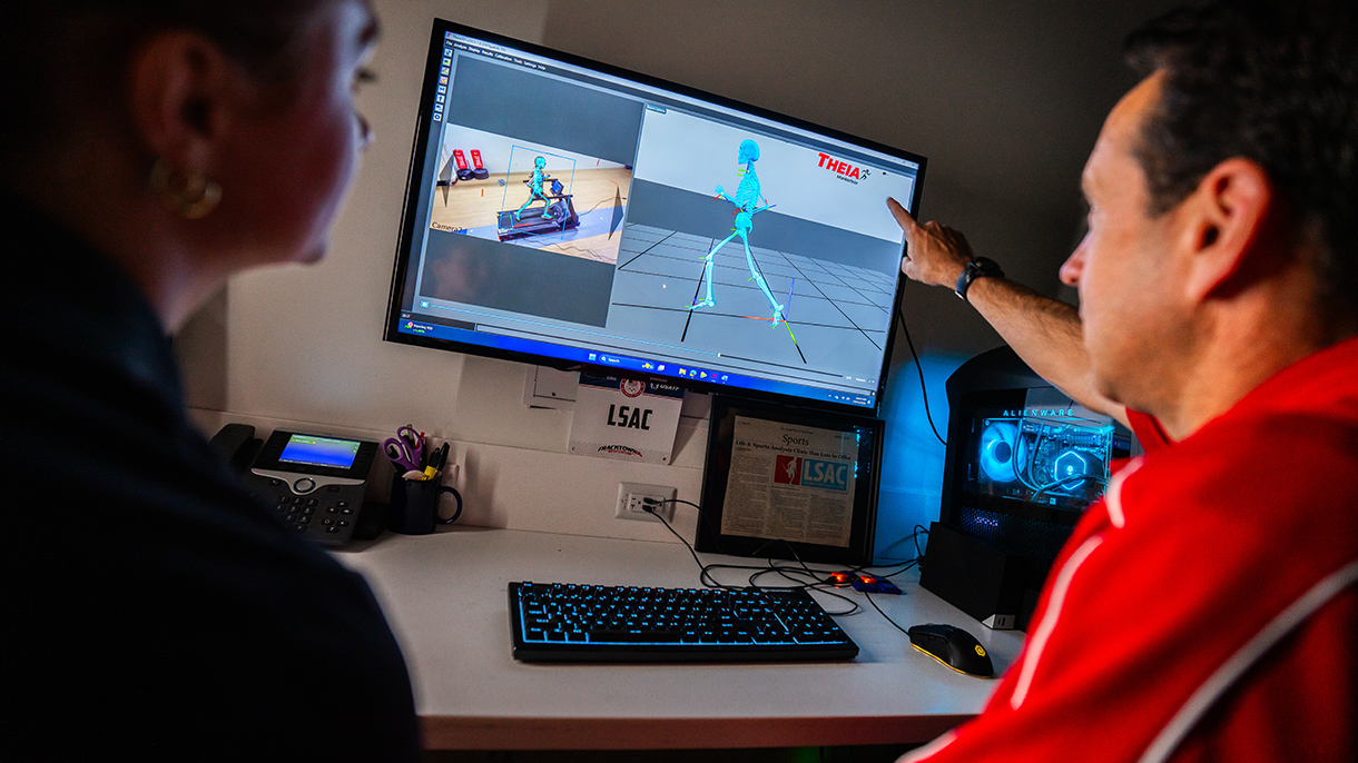 an exercise scientist looks at gait results with a student