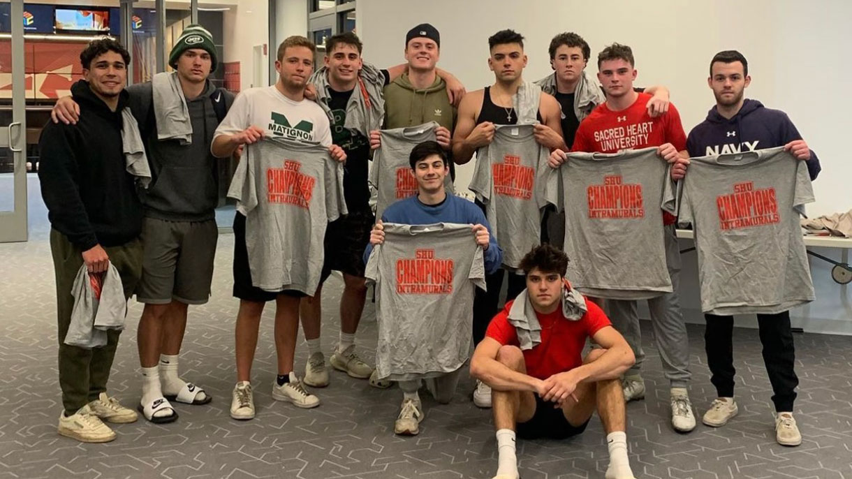 Members of Pi Kappa Phi holding t-shirts