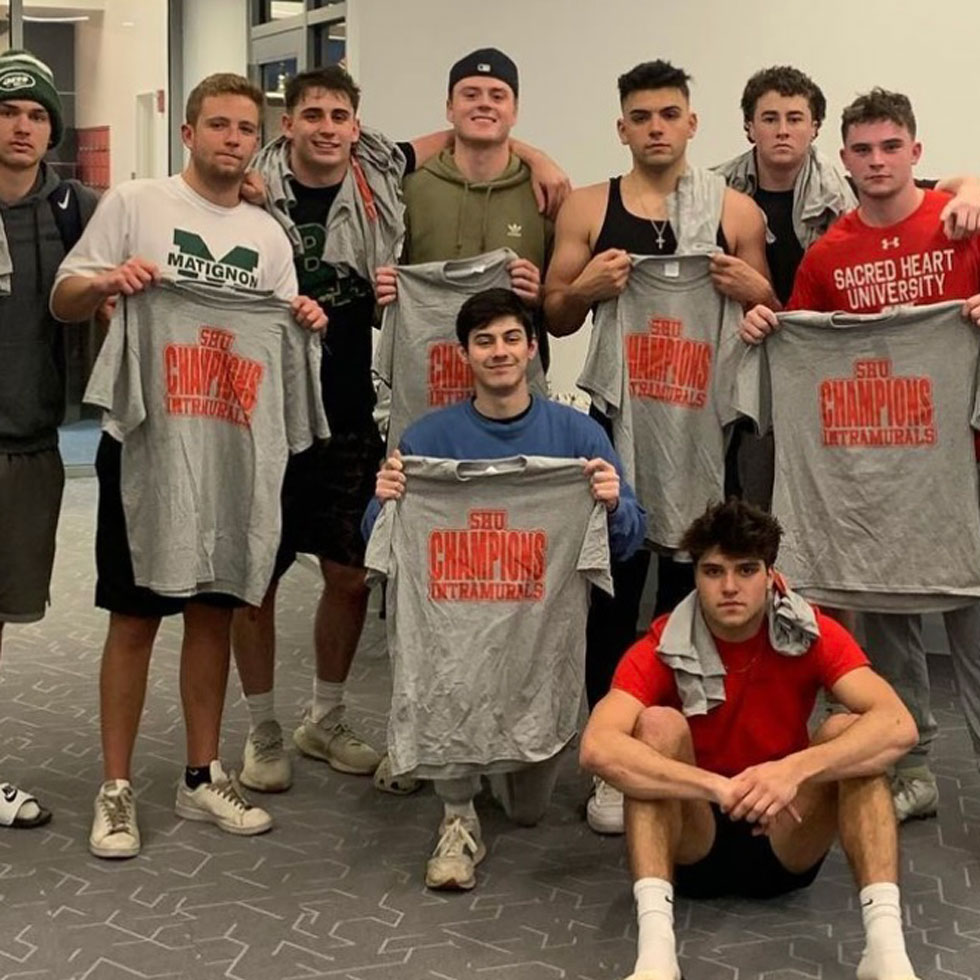 Members of Pi Kappa Phi holding t-shirts
