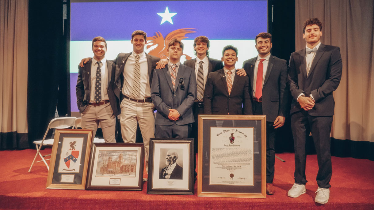 Members of Beta Theta Pi at brotherhood event. All dressed in suit jacket, tie, dress pants