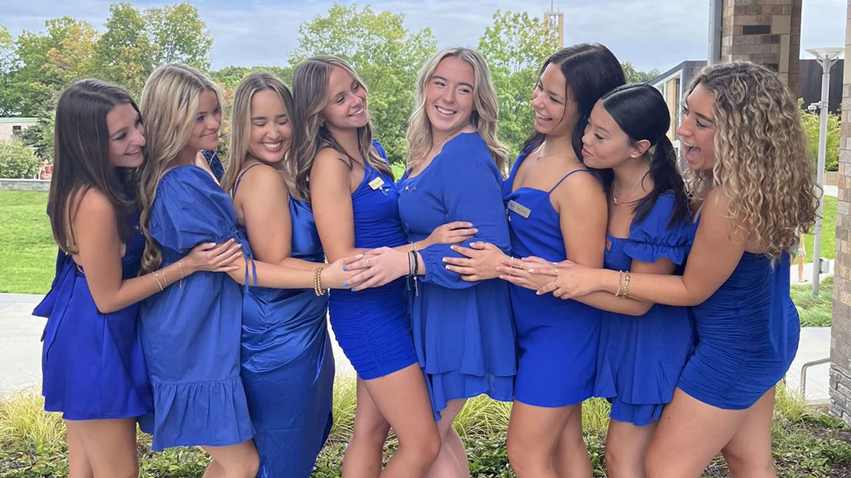 Chi Omega members dressed in blue dresses for recruitment
