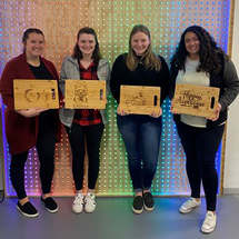 Students in the Idea Lab holding cutting boards