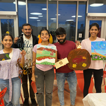 Students holding up their artwork