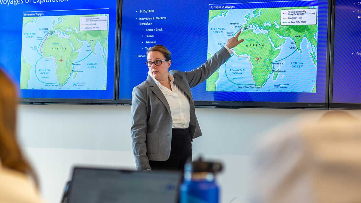 Professor pointing at map
