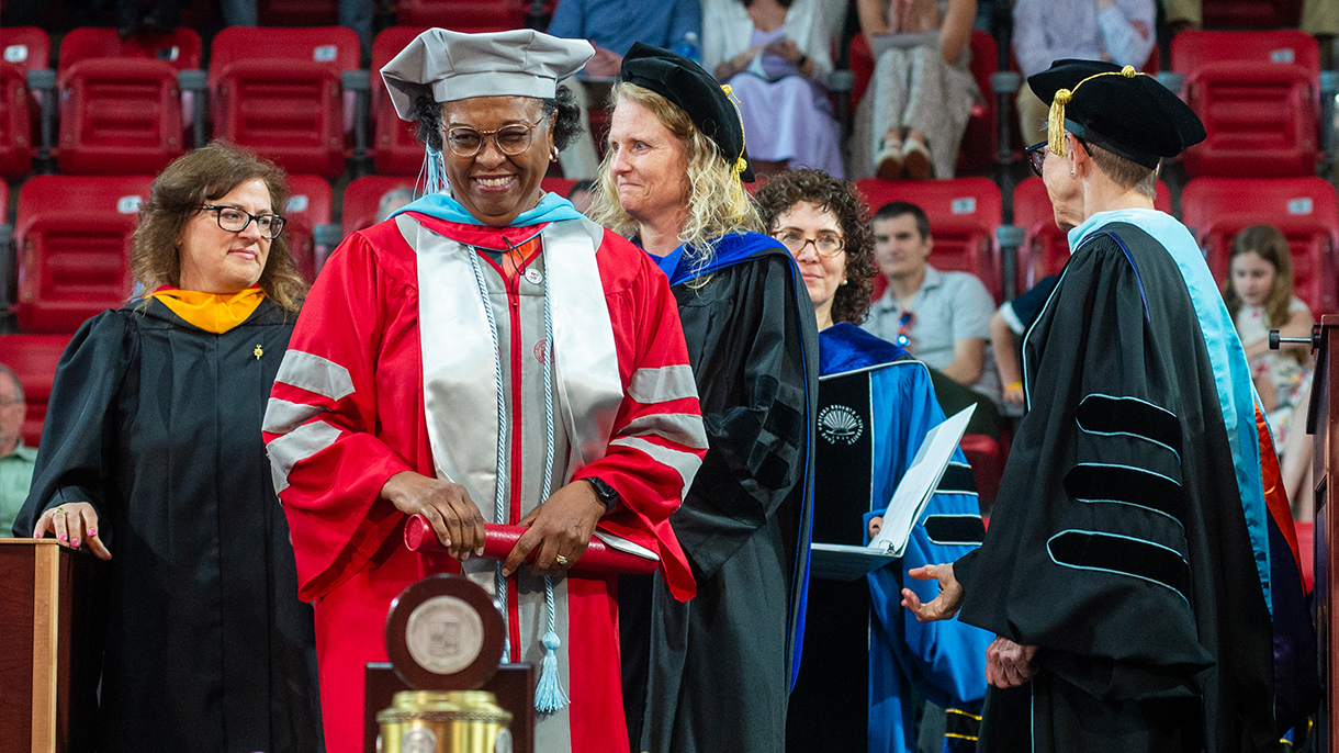 Demetria Walters receives her doctorate of education at commencement