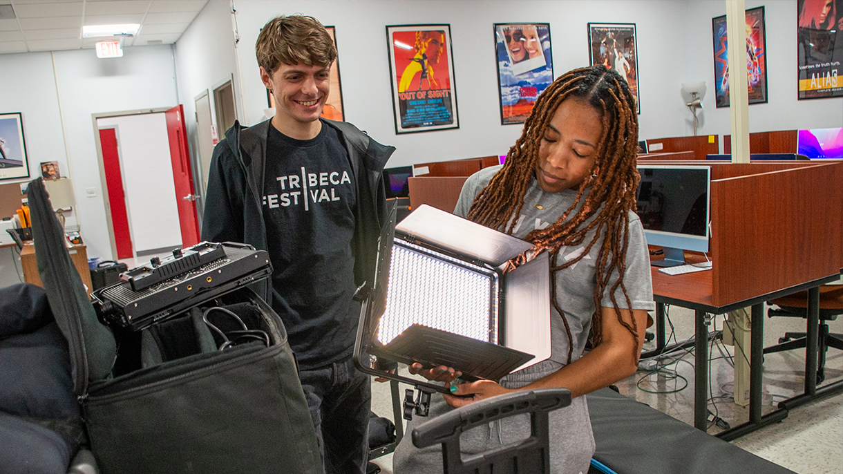 film students pack lighting equipment
