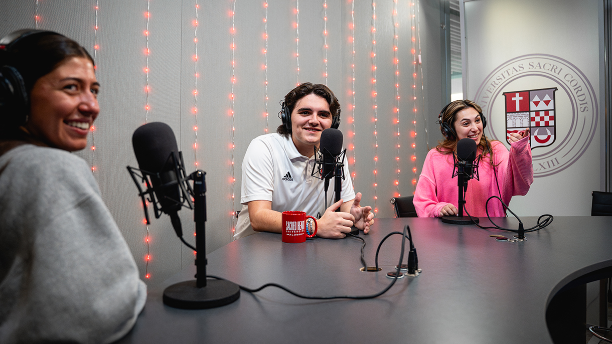 three people in a podcasting studio