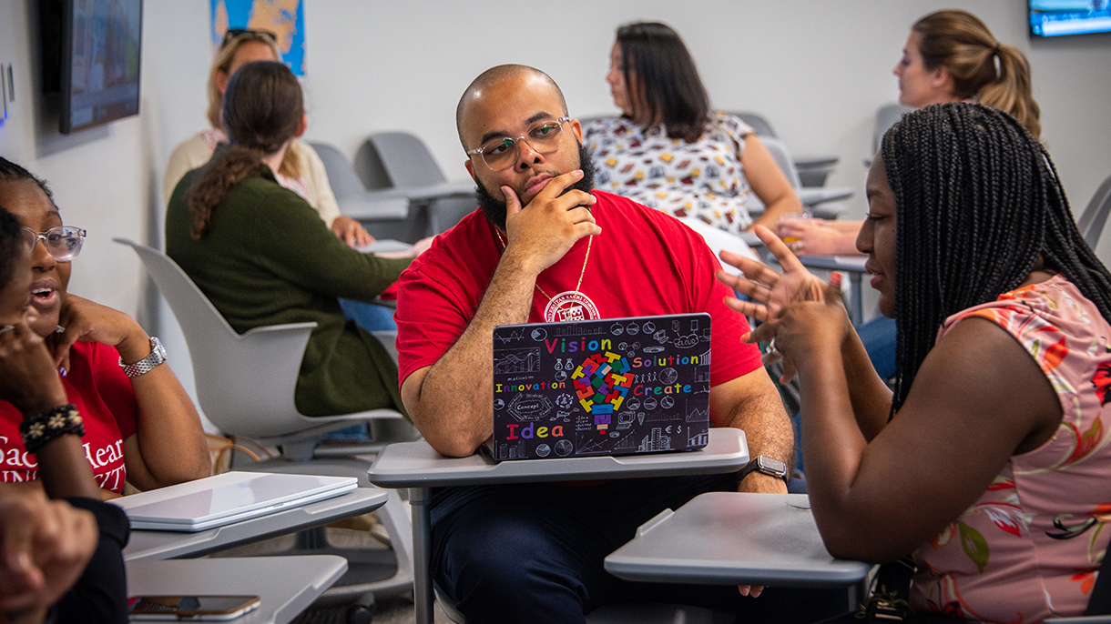 students conversing with each other in a classroom