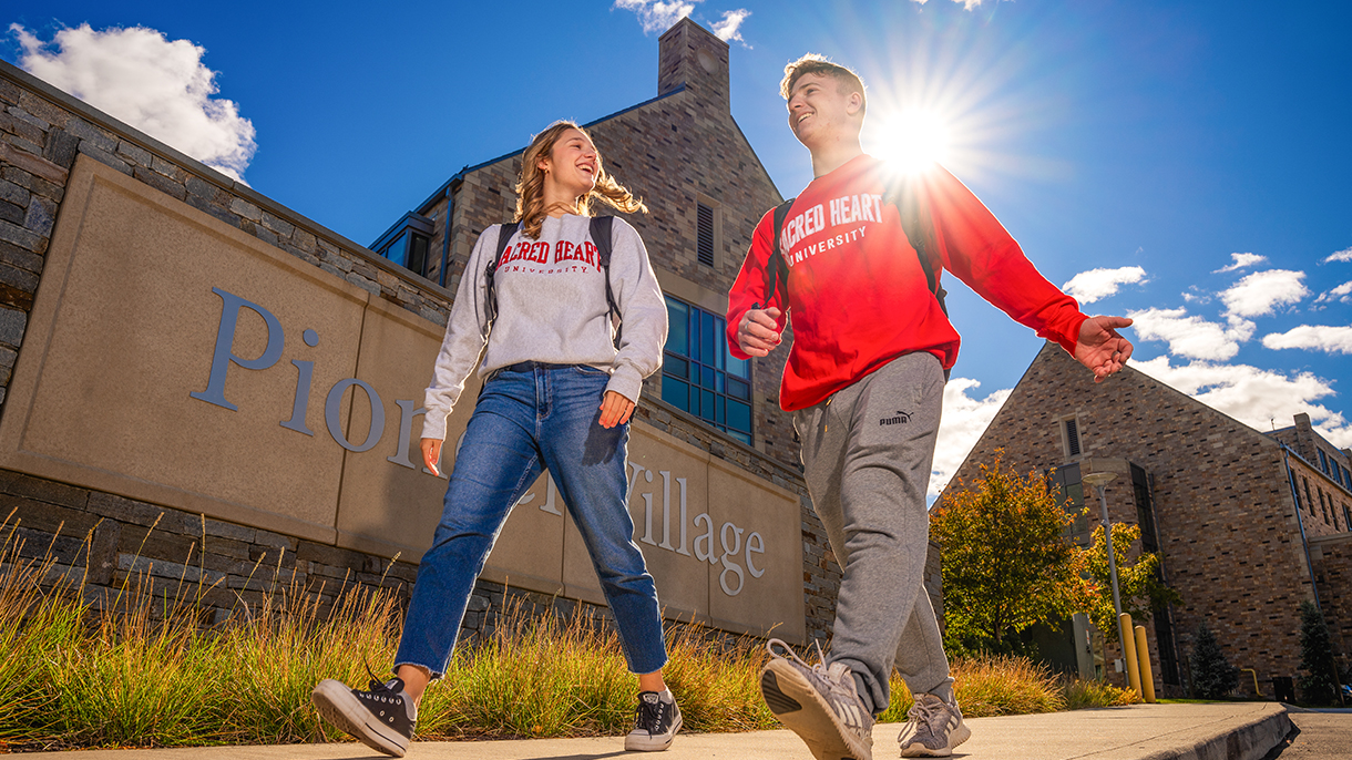 two college students walking together in sunshine