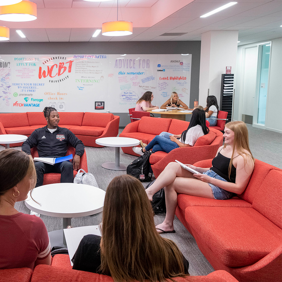 college students talking in a lounge area