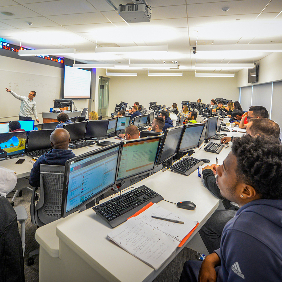 Graduate students and a professor in class