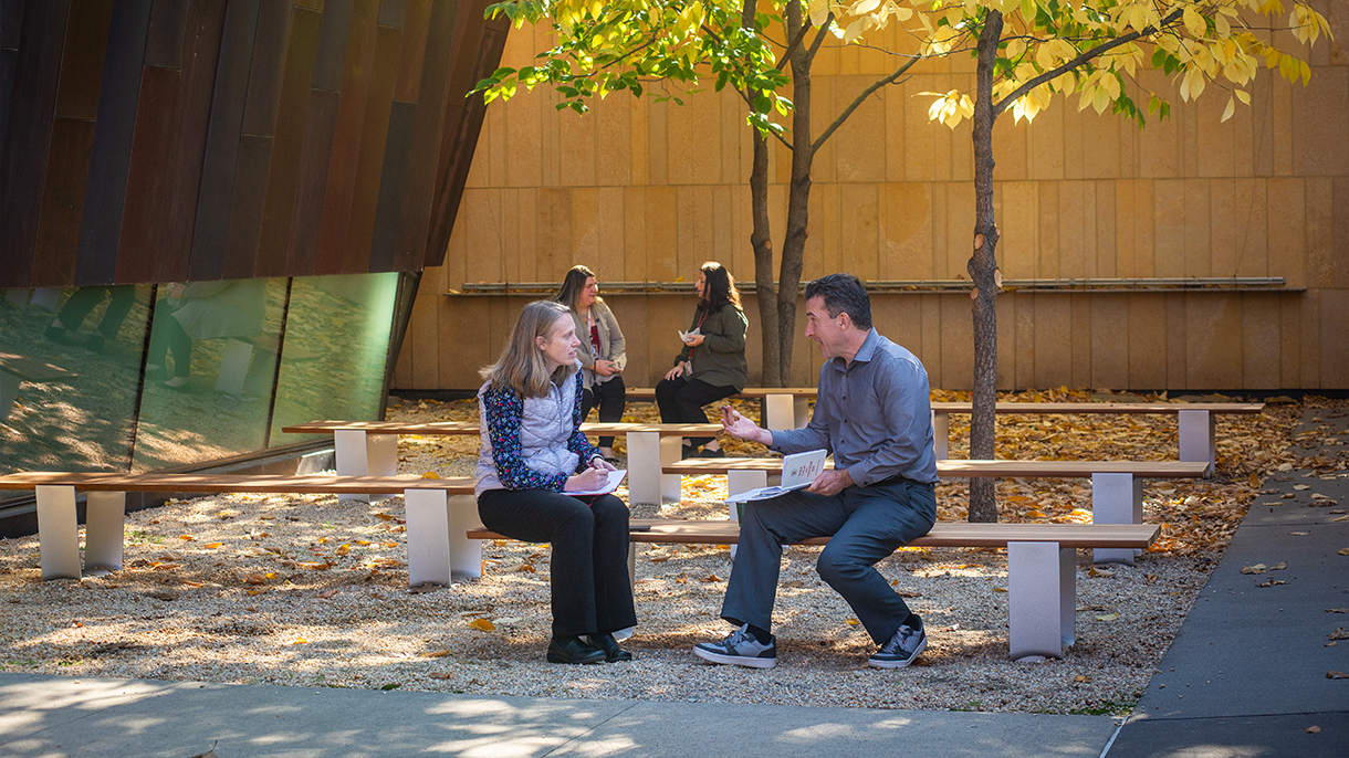 people sitting on benches talking