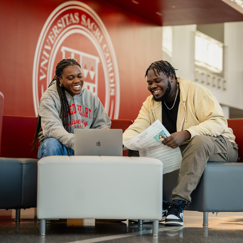 Two students looking at laptop