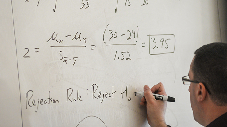 Professor writing on the board