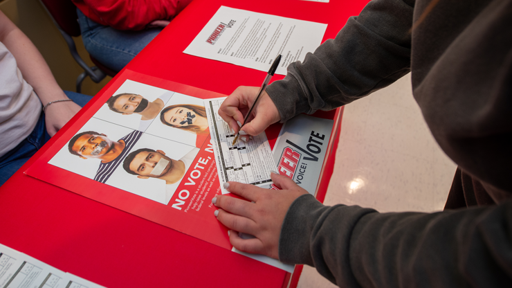 Student filling in a voting ballot