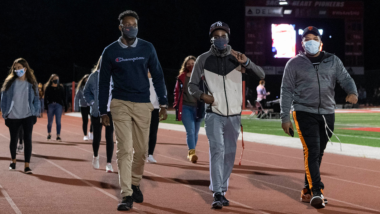 Students walk around the Campus Field track as part of a suicide prevention walk on September 20, 2020.