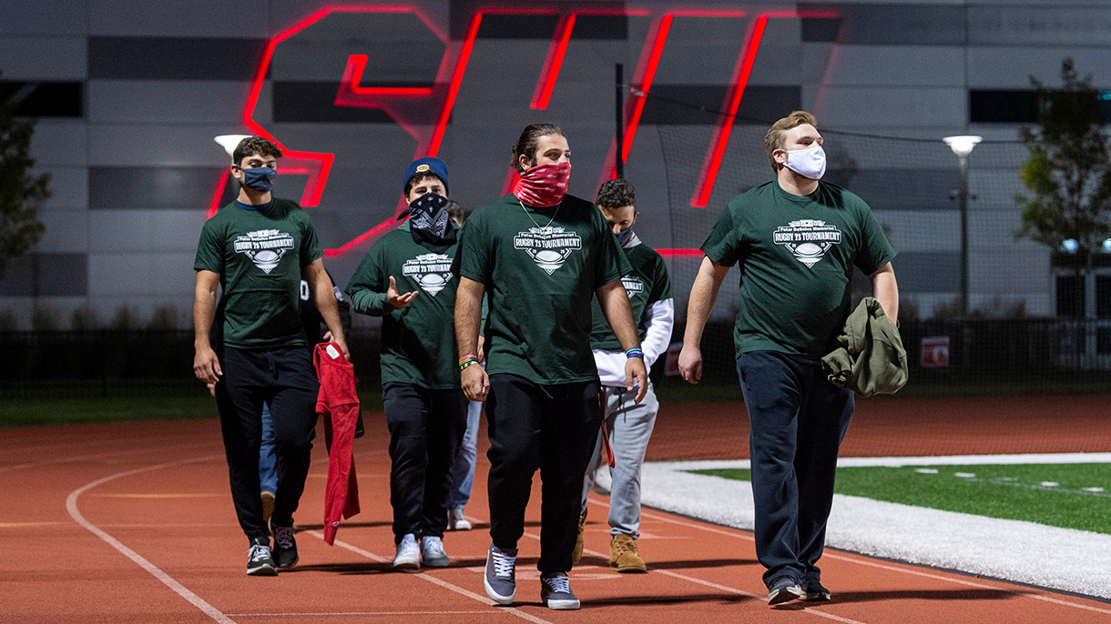 Students walk around the Campus Field track as part of a suicide prevention walk on September 20, 2020.