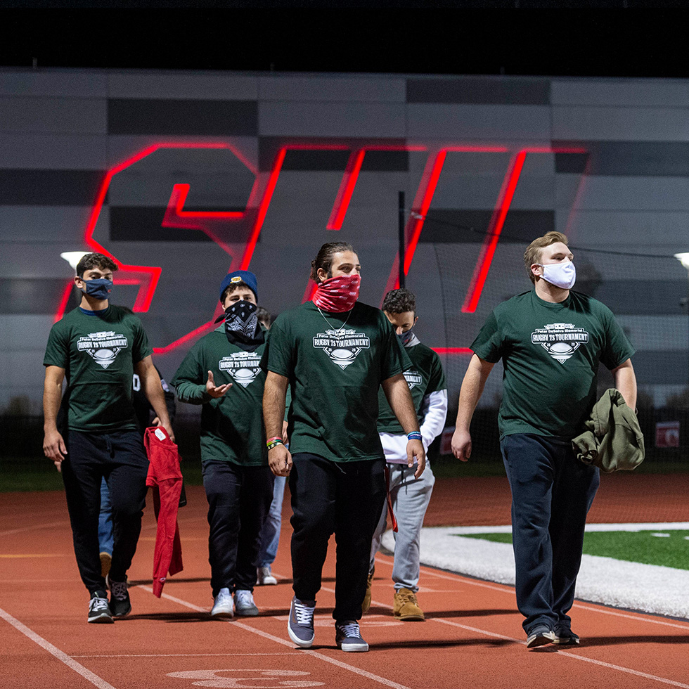 Students walk around the Campus Field track as part of a suicide prevention walk on September 20, 2020.