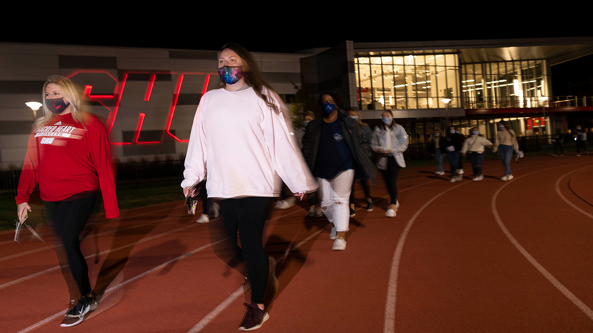 Students walk around the Campus Field track as part of a suicide prevention walk on September 20, 2020.