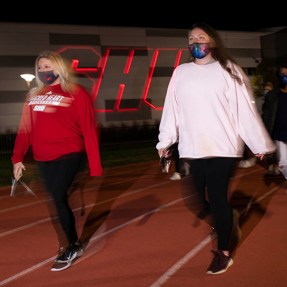 Students walk around the Campus Field track as part of a suicide prevention walk on September 20, 2020.