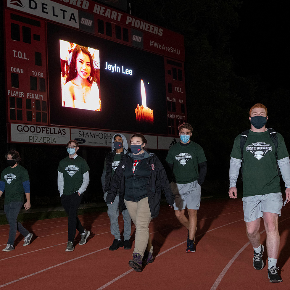 Students walk around the Campus Field track as part of a suicide prevention walk on September 20, 2020.