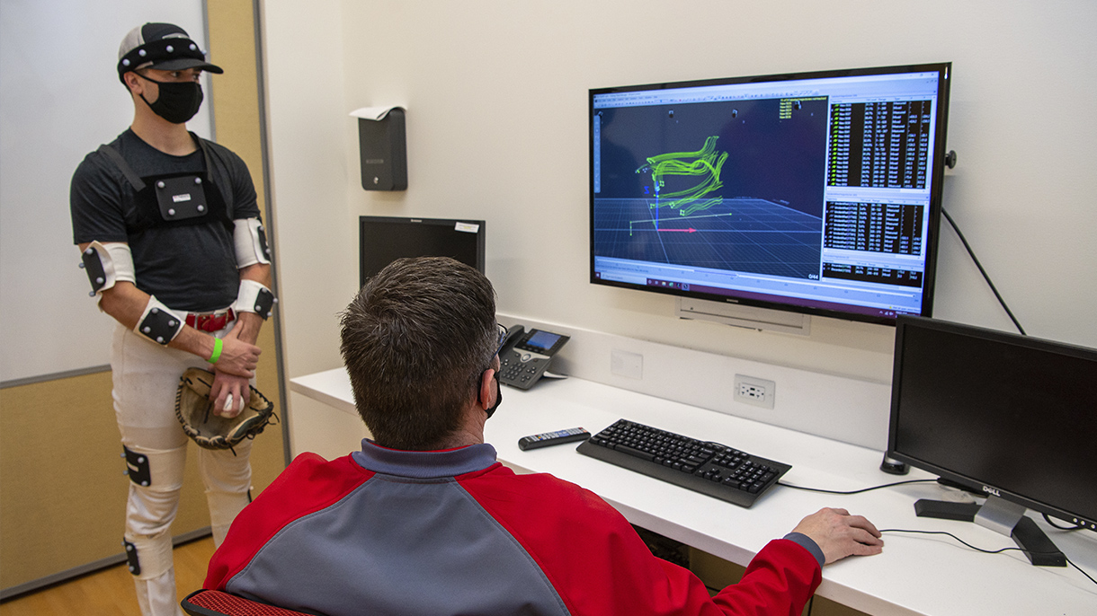 an exercise scientist goes over the results of a pitcher's motion analysis