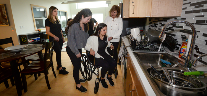 Professor and students working with patient in the OT suite