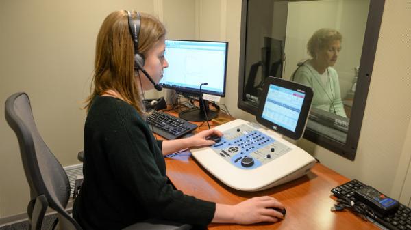person testing hearing in an audiology lab