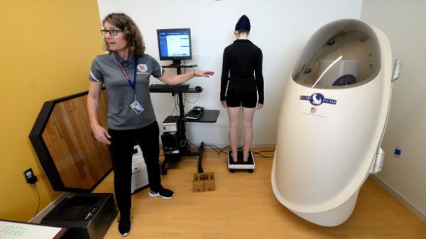 professor in a human performance lab with bod pod