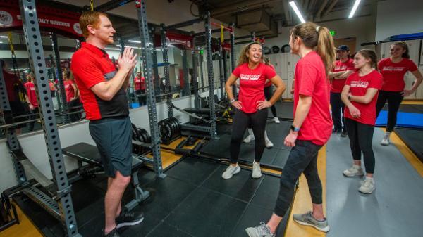 Professor and students in the Strength and Conditioning Lab