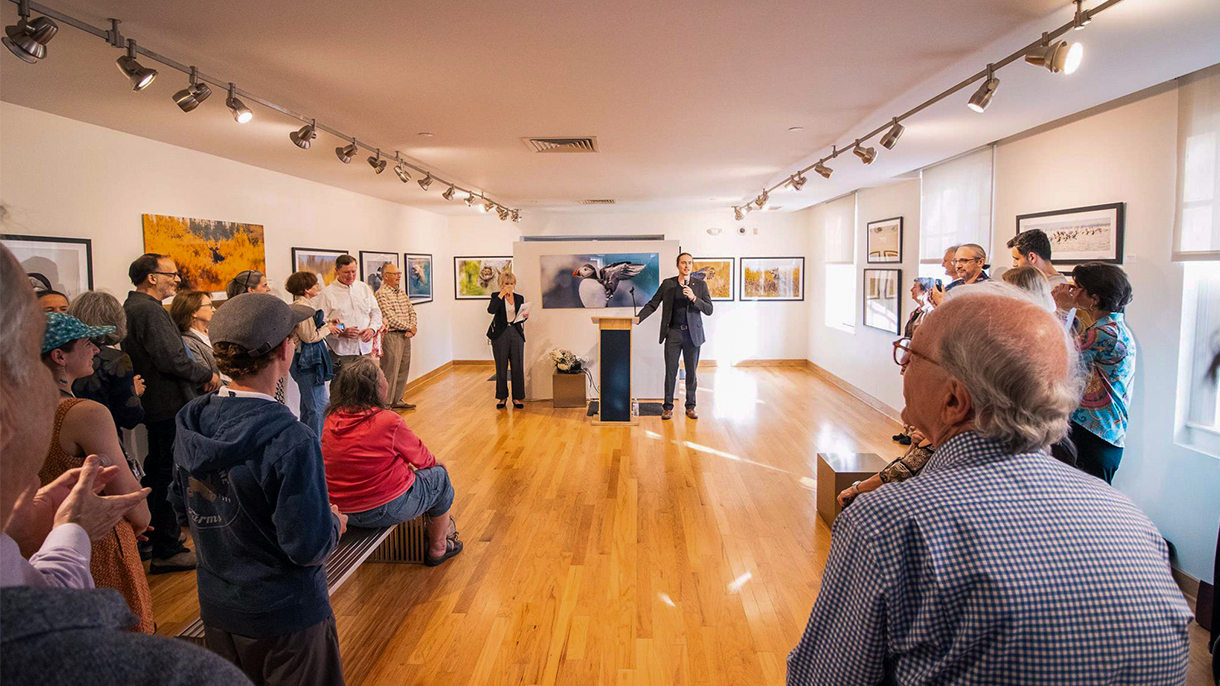 Tomas Koeck speaking in an art gallery