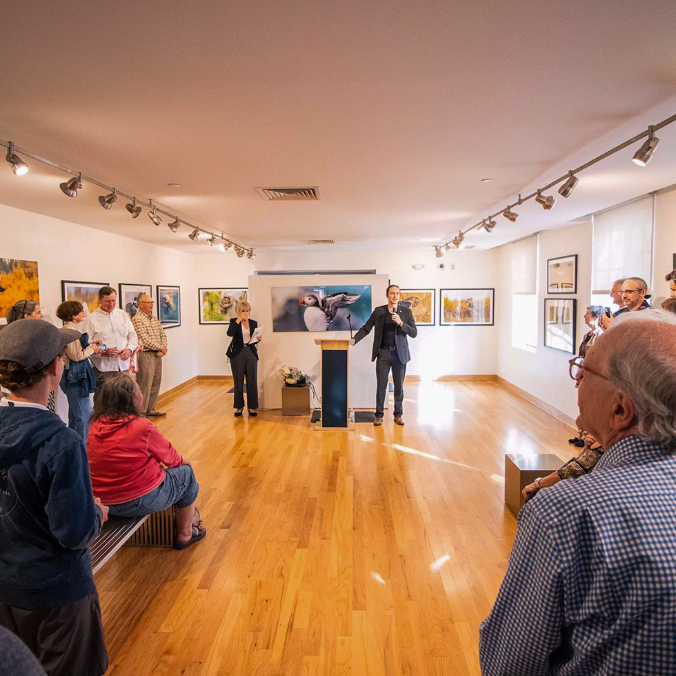 Tomas Koeck speaking in an art gallery