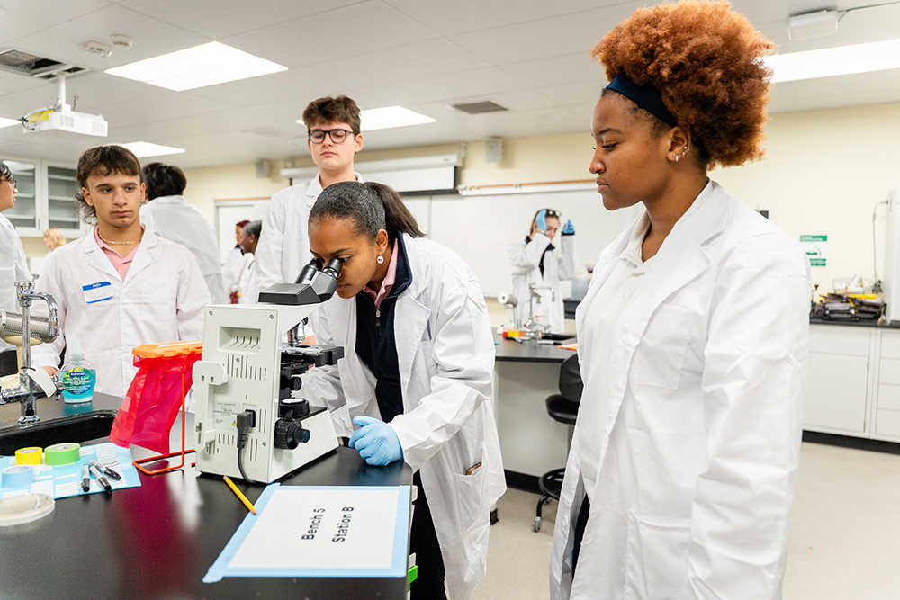Students looking through microscope in lab