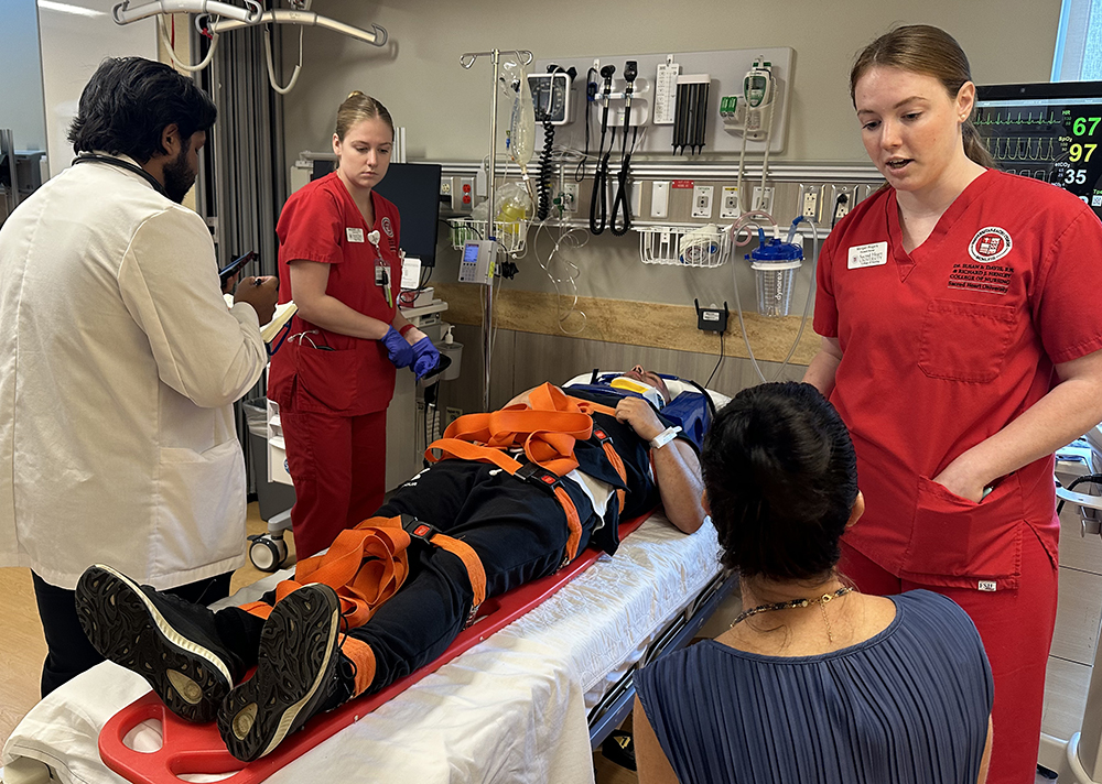 Health professions students assessing patient during simulation